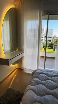 a bedroom with a bed and a window at Seaside studio with pool in Dar Bouazza