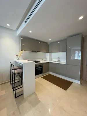 a kitchen with a white counter and a table at Sublime Résidence - Dreamy Appartment 1BR in Maarif
