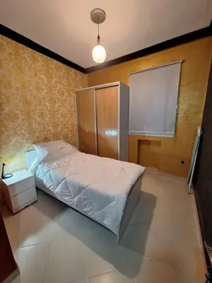 a bedroom with a white bed and a window at charmant appart à Mohammedia in Mohammedia