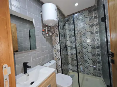 a bathroom with a toilet and a sink and a shower at Anchor point in Dar Bouazza