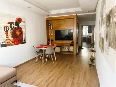 a living room with a table and a television at One-Five Racine by IB Signature, Stylish 2BR Apt, 24x7 Security, WiFi, Self check-in, City View, City Centre, close to cafes and restaurants in Casablanca