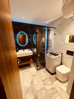 a bathroom with a toilet and a sink and a mirror at Studio luxueux à Maarif in Casablanca