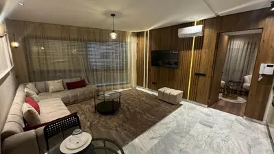 a living room with a couch and a tv at Studio luxueux à Maarif in Casablanca