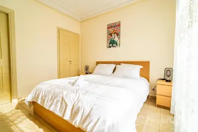 a bedroom with a large white bed in it at Gauthier 5-Star Luxury Gem in Casablanca