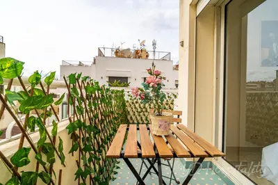 a wooden table on a balcony with a plant at Gauthier 5-Star Luxury Gem in Casablanca