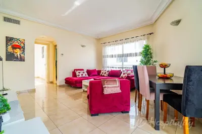 a living room with a red couch and a table at Gauthier 5-Star Luxury Gem in Casablanca