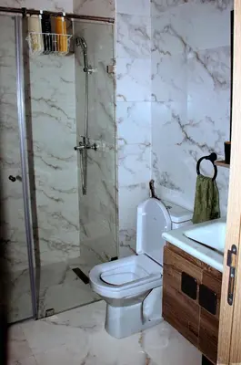 a bathroom with a shower and a toilet and a sink at cosy studio au coeur de casablanca in Maarif