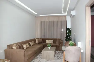 a living room with a brown couch and a table at cosy studio au coeur de casablanca in Maarif