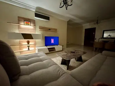 a living room with a couch and a tv at Casablanca Central Suites - Casa Port in Casablanca