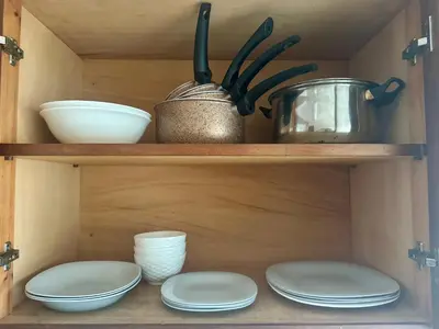 a wooden shelf with plates and bowls and utensils at Casablanca Central Suites - Casa Port in Casablanca
