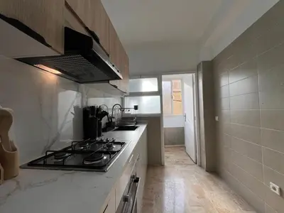 a kitchen with a stove and a counter top at Charmant Appart Moderne au Cœur de Rabat avec Fibre in Rabat