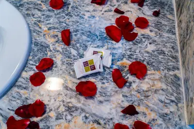 a bunch of red roses on a table with a camera at Appart-Hôtel BEL ANFA in Casablanca