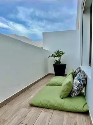 a room with a bean bag chair and a potted plant at Luxurious Sea View 2 Bedroom Apartment in Anfa