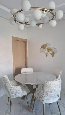 a dining room with a white table and chairs at Vue mer et parc, terrasse filante in Aïn Harrouda