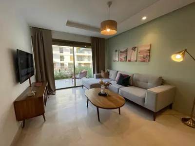 a living room with a couch and a table at Charmant studio avec vue sur mer in Rabat