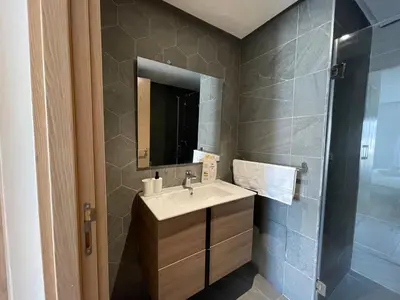 a bathroom with a sink and a mirror at Charmant studio avec vue sur mer in Rabat