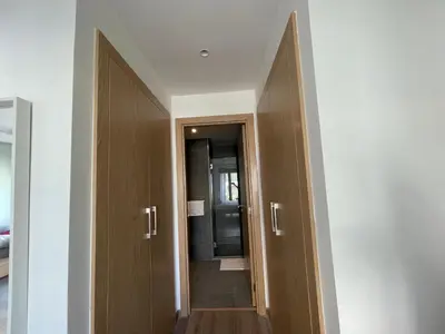 a hallway with two wooden doors and a mirror at Charmant studio avec vue sur mer in Rabat