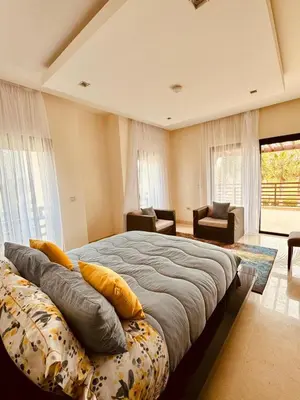 a bedroom with a large bed with pillows on it at Mazagan private villa in El Jadida