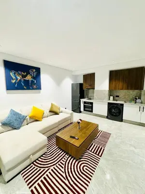 a living room with a couch and a coffee table at Chic Apartment in Casa Finance District -Open view - Fast WIFI in Casablanca