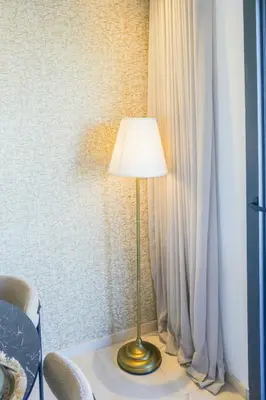 a lamp sitting on a table next to a curtain at Résidence Tour 33 - CFC district in Casablanca