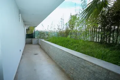 a walkway leading to a yard with a fence at Appartement luxueux avec jardin in Rabat