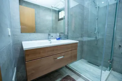 a bathroom with a sink and a shower at Appartement luxueux avec jardin in Rabat
