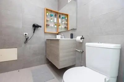a bathroom with a toilet and a phone in it at Modern & Chic APT Prestigia by MERAT HOME in Rabat