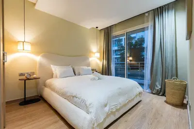 a bedroom with a white bed and a large window at Modern & Chic APT Prestigia by MERAT HOME in Rabat