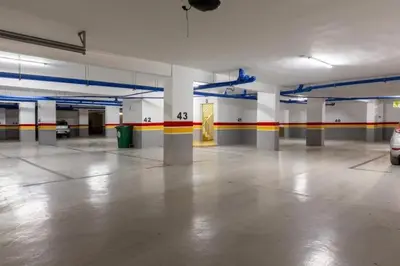 an empty parking garage with a car parked in it at Apartment in Dar Bouazza with Pool, Gym & Kids Playground in Dar Bouazza