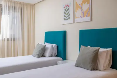two beds in a room with blue and white at Charming Cozy apartments with terrace, Haut Agdal in Rabat