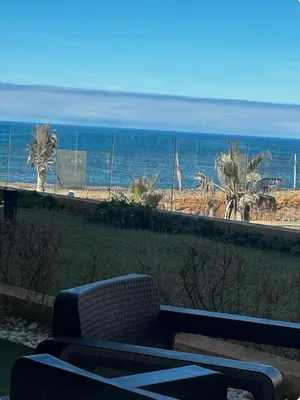 a couch sitting in front of a view of the ocean at La perle du carrousel in Rabat