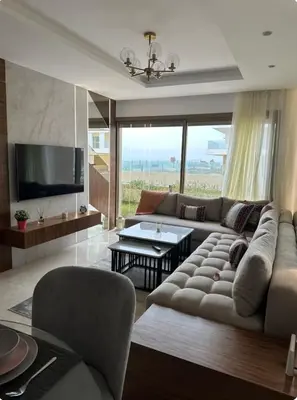 a living room with a couch and a tv at La perle du carrousel in Rabat