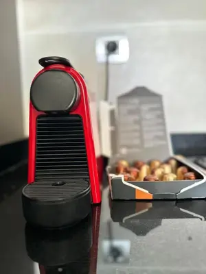 a red appliance on a counter with a box of apples at Spacious Apartment 3BR by CH Hay riad, Rabat in Rabat