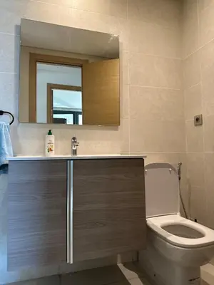 a bathroom with a toilet and a sink and a mirror at Spacious Apartment 3BR by CH Hay riad, Rabat in Rabat