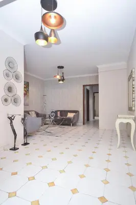 a living room with a white floor and a ceiling at Cozy 2 BR Gauthier Oasis in Casablanca