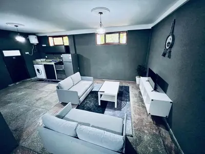 a living room with white couches and a table at Organizado apartamento 2 in Mediouna