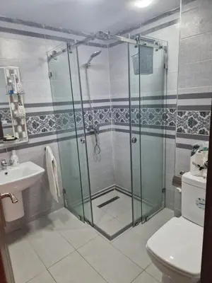 a bathroom with a shower and a toilet and a sink at الشروق in Pont Blondin