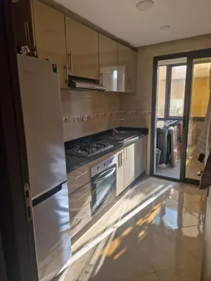 a kitchen with a stainless steel refrigerator and stove at الشروق in Pont Blondin