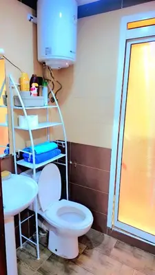 a bathroom with a white toilet and a shelf at Mi mini estudio 3 in Rabat