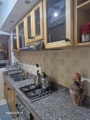 a kitchen counter with a stove and a sink at Baghdad 4 in Aïn Harrouda