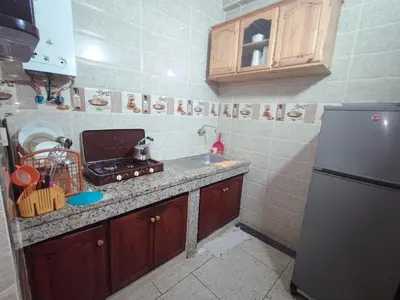 a small kitchen with a sink and a refrigerator at de Luxe in Rabat