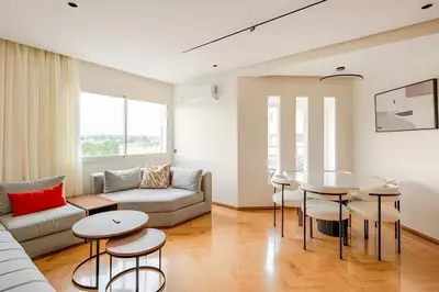 a living room with a couch and a table at Luxury Central 3BR 5min from Beach & Shopping in Casablanca