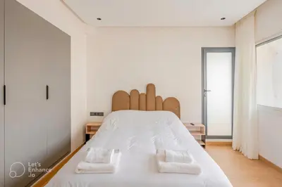 a bedroom with a large white bed with two pillows at Luxury Central 3BR 5min from Beach & Shopping in Casablanca