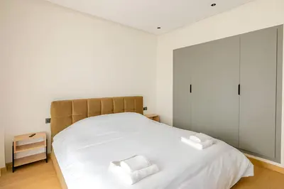 a bedroom with a large white bed with two pillows at Luxury Central 3BR 5min from Beach & Shopping in Casablanca