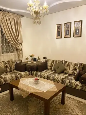 a living room with a couch and a table at Luxurious Holiday Home2 in Temara