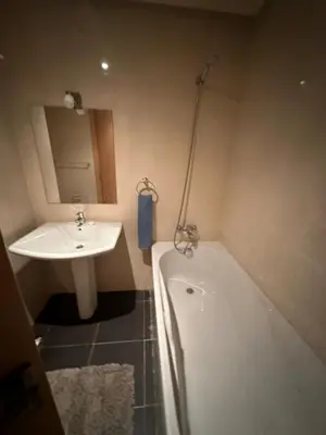 a bathroom with a sink and a bath tub next to a sink at Appartement haut standing Mohammedia Parc in Mohammedia