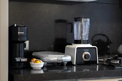 a blender sitting on top of a kitchen counter at Appart Moderne Tamaris Piscine, Plage et Confort in Tamaris