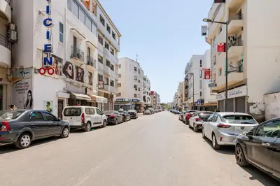a street with cars parked on the side of the road at Cozy studio moderne Agdal in Rabat