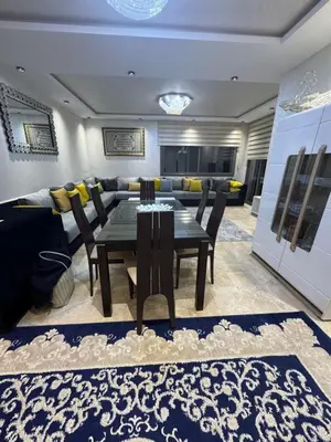 a dining room with a table and chairs and a couch at Appartement 3 chambres moderne a californie Casablanca in Casablanca