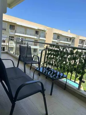 two chairs on the roof of a building at Beautiful apartment with pool & beach nearby in Bouznika
